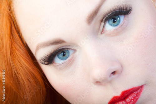 Red hair girl in pin-up style portrait shot in studio