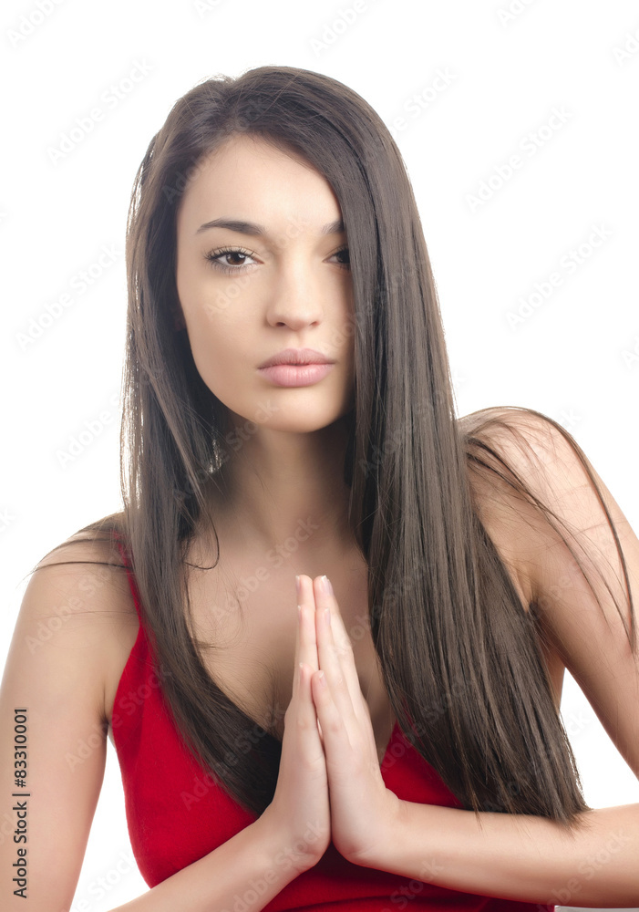 Sexy girl in red dress praying.Woman keeping the hands together Sexy girl in red dress praying.Woman keeping the hands together