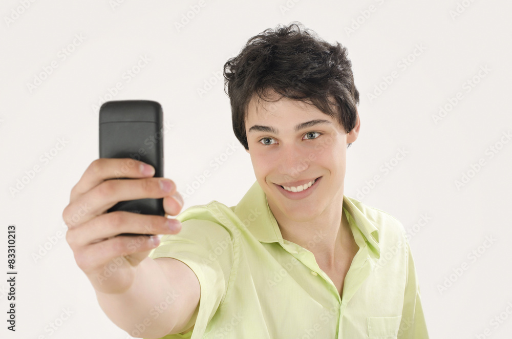 Happy young man taking a selfie photo with his smart phone.