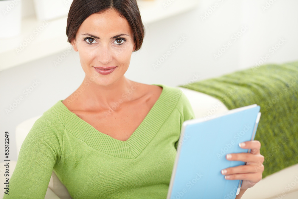 Fototapeta premium Relaxed young woman holding a tablet