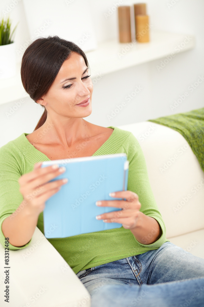 Beautiful woman thinking while using a tablet Beautiful woman thinking while using a tablet