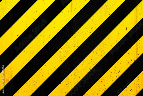 Concrete wall with black and yellow stripes