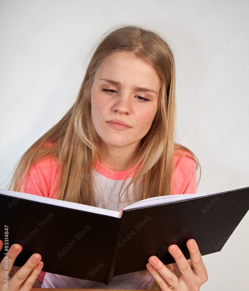 Scandinavian cute young girl reading a book Scandinavian cute young girl reading a book