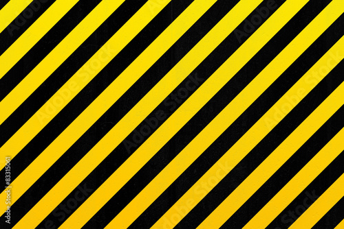 Concrete wall with black and yellow stripes