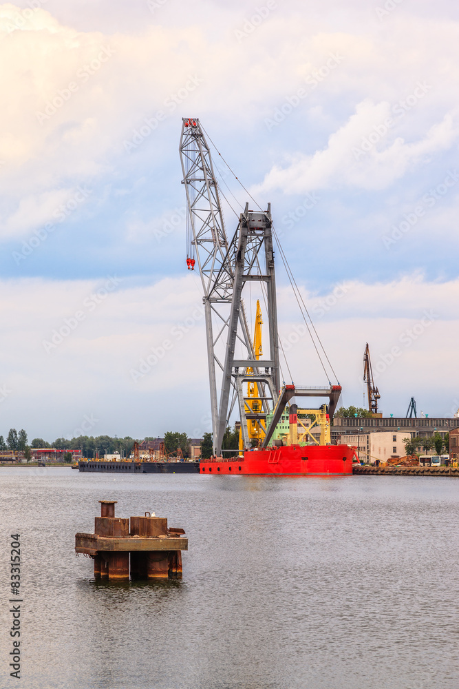 The floating crane moored at the quayside. The floating crane moored at the quayside.