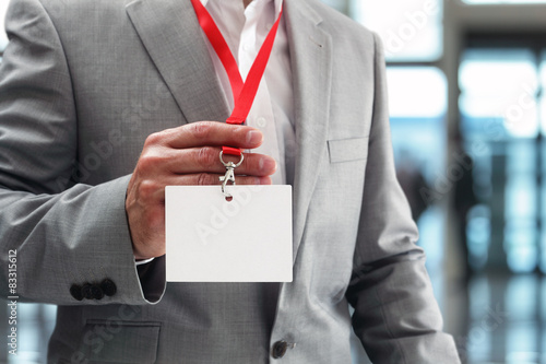 Konstfotografi Businessman holding blank ID badge