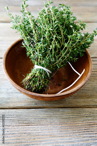 Fresh thyme in a bowl on wooden boards