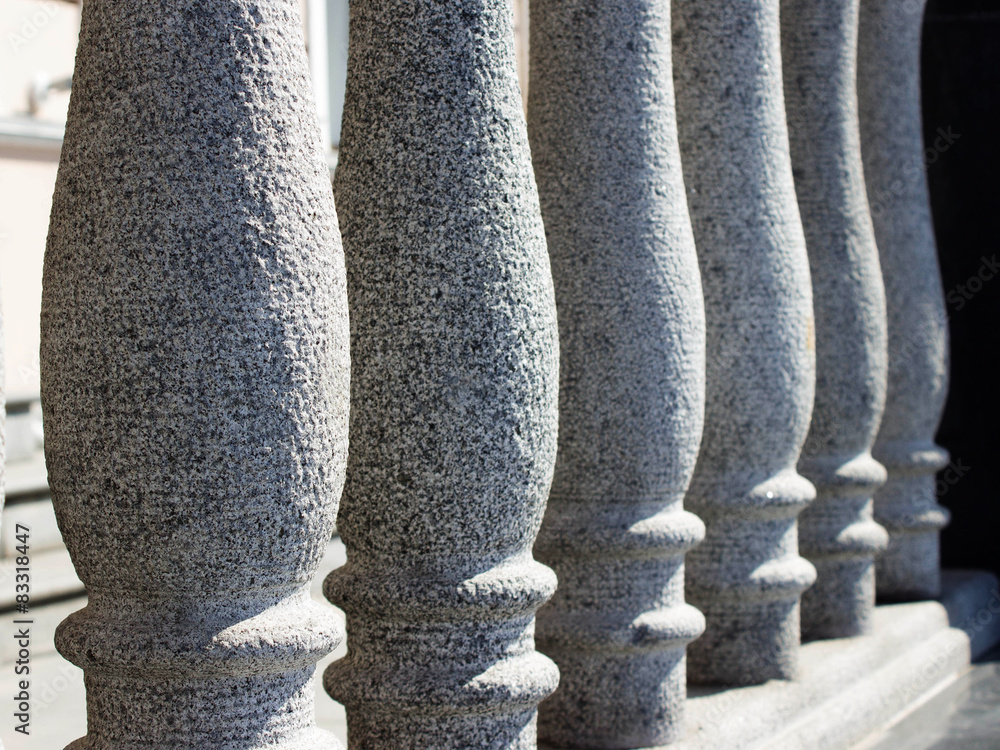 row of white marble concrete balusters and rough surface