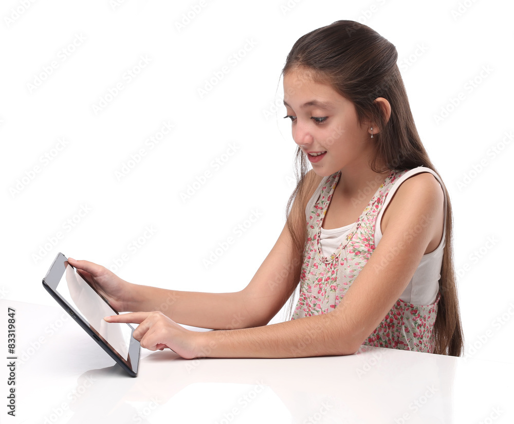 Beautiful pre-teen girl with a tablet computer. Isolated. 