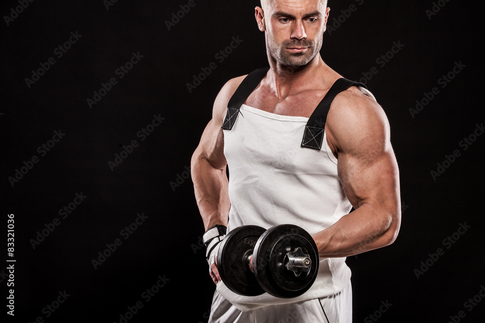 Hispanic young muscular man doing heavy dumbbell exercise for bi