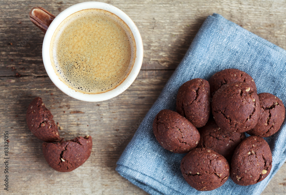 Italian chocolate cookies with walnuts and a cup of coffee