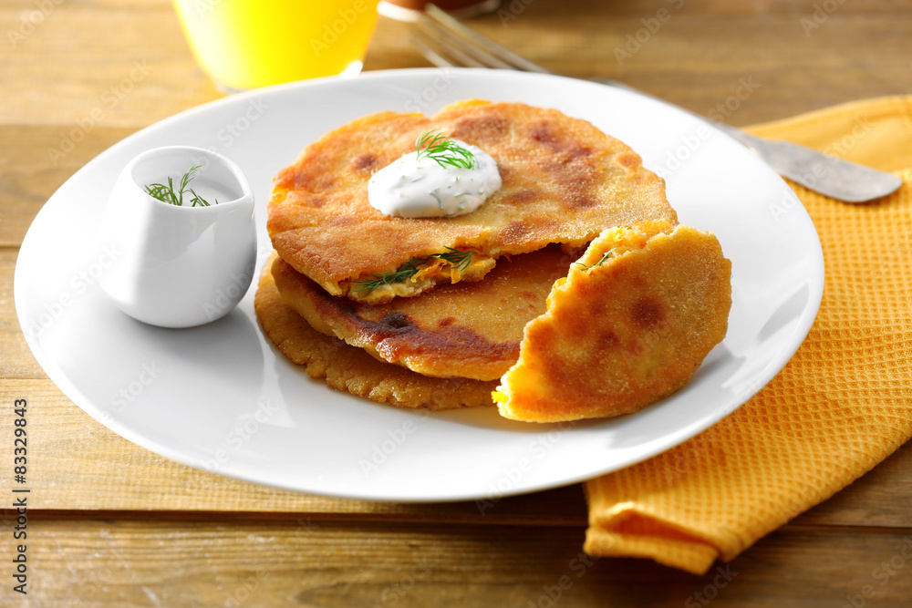 Stack of corn tortillas with stuffing and glass of juice on wooden table background Stack of corn tortillas with stuffing and glass of juice on wooden table background
