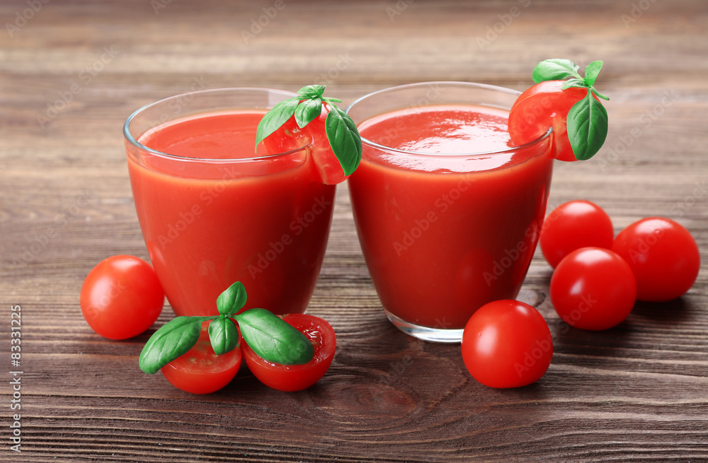 Glasses of tomato juice with vegetables on wooden background Glasses of tomato juice with vegetables on wooden background