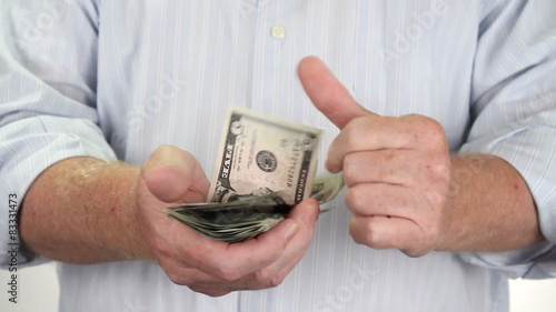 Man holding USA money in hands counts the dollars quickly.