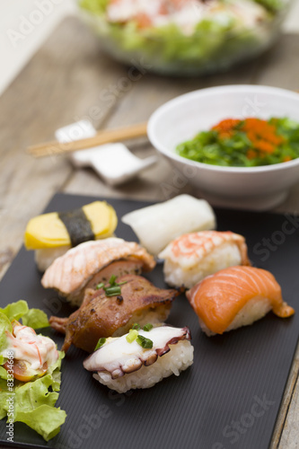 Sushi assortment on black dish, close up