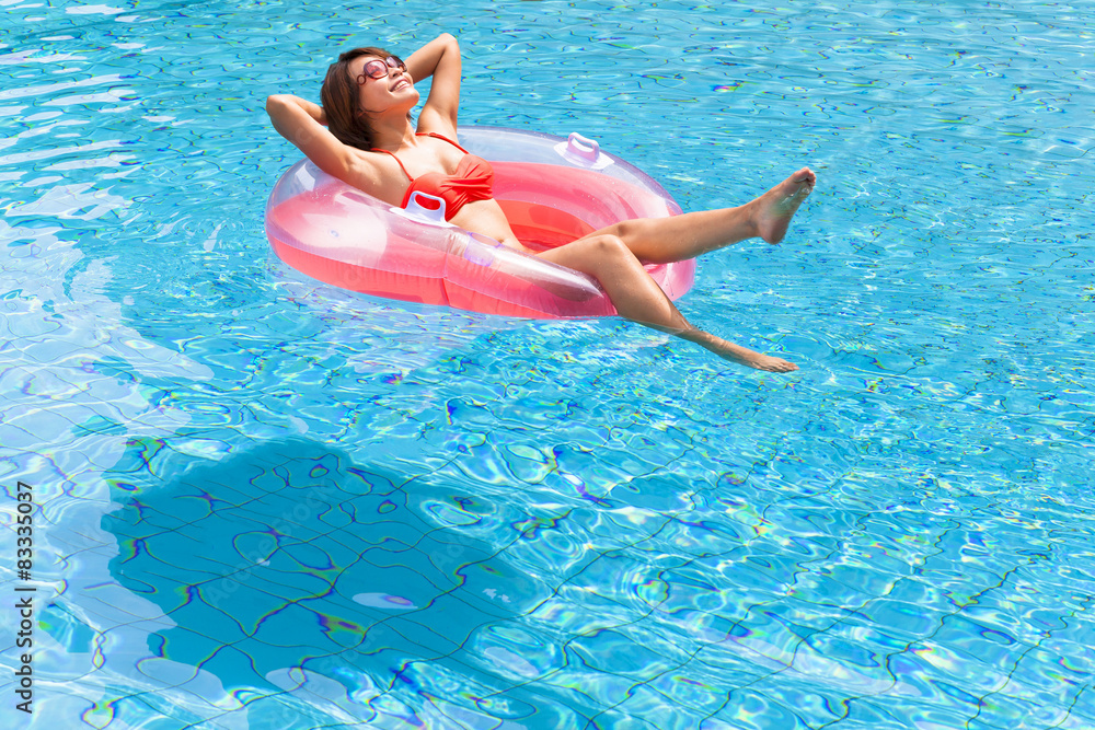 Young woman relaxing in swimming pool