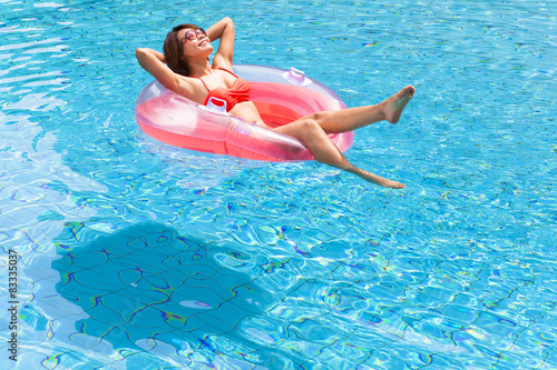 Young woman relaxing in swimming pool