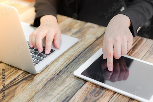 Closeup of business woman hand typing on laptop keyboard ,sun fl