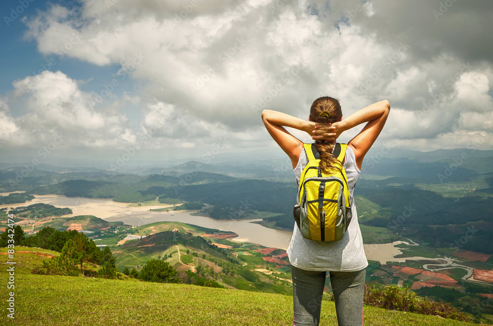 Portrait of happy traveler woman with backpack standing on top o - obrazy, fototapety, plakaty 