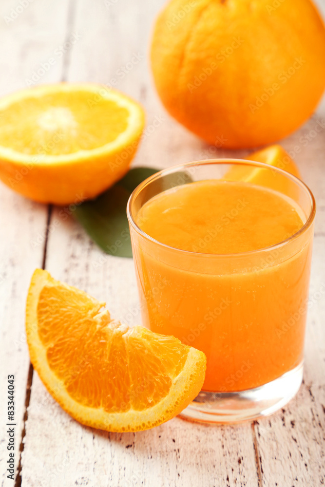Orange fruit and glass of juice on white wooden background Orange fruit and glass of juice on white wooden background