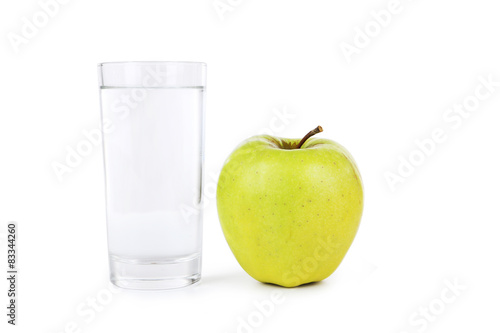 Green apple with glass of water isolated on white