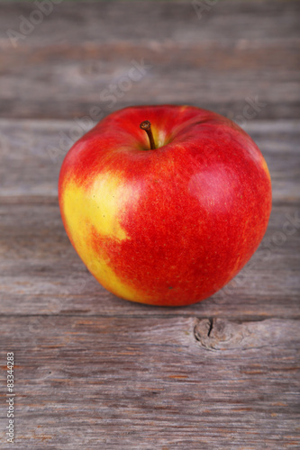 Red apple on grey wooden background