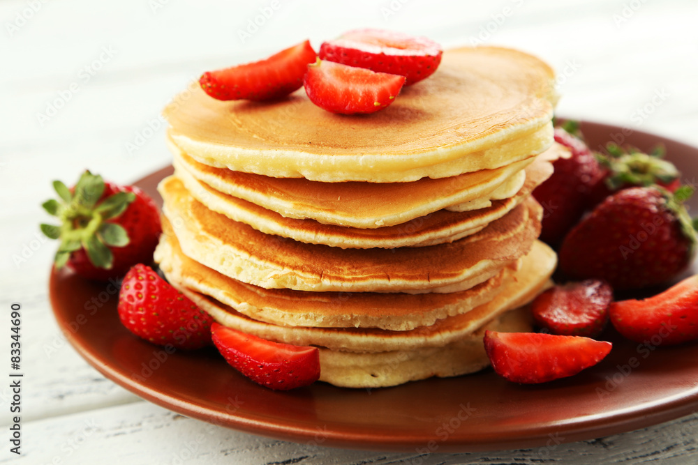 Delicious pancakes with strawberry on white wooden background Delicious pancakes with strawberry on white wooden background