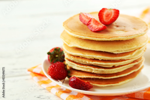 Delicious pancakes with on white wooden background