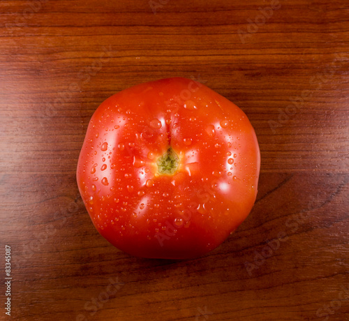 Single Red Tomato on Rustic Wood
