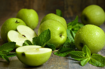 Green apples with mint leaves.