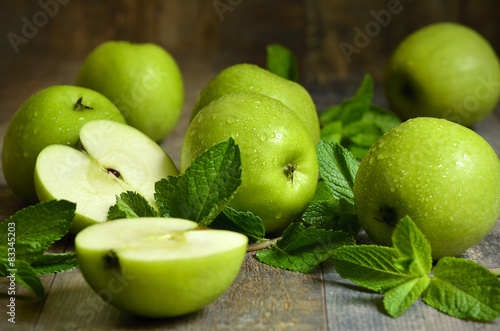 Green apples with mint leaves.