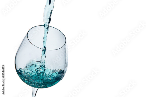 Water poured into a glass on a white background