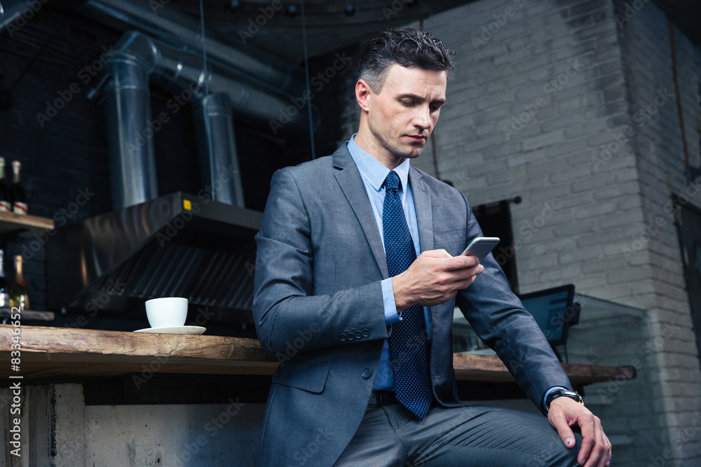Businessman using smartphone in cafe Businessman using smartphone in cafe