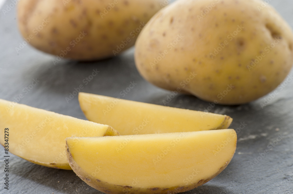 Cut potatoes close up raw on black background Cut potatoes close up raw on black background