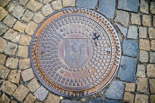 Hatch of sewage on the paving road