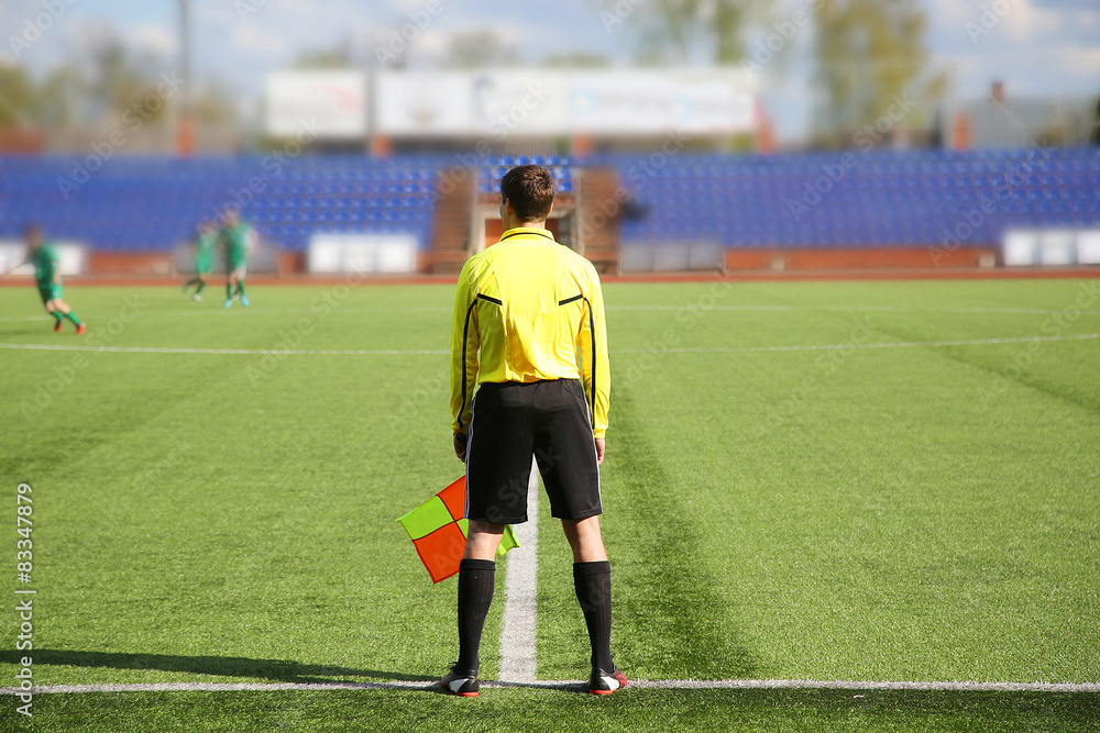 Fototapeta premium Football. Linesman in yellow jersey