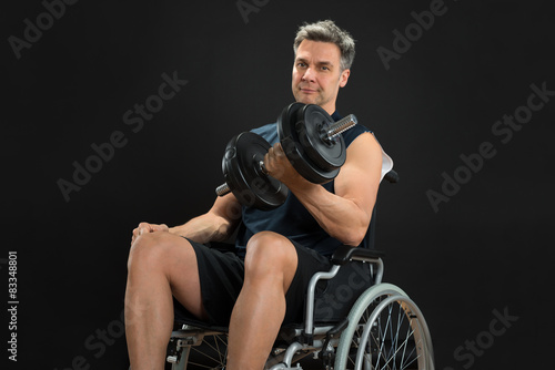 Handicapped Man On Wheelchair Working Out With Dumbbell