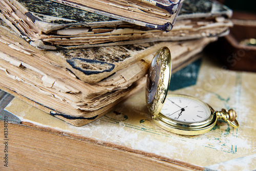 Old books and  pocket watch photo