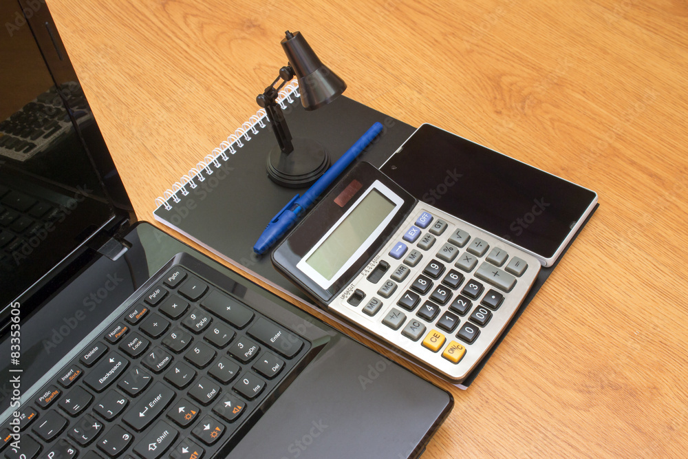 calculator notebook laptop and phone on the table calculator notebook laptop and phone on the table