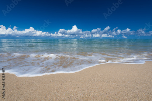 Fototapeta Naklejka Na Ścianę i Meble -  sea waves lash line impact on the sand beach under blue sky