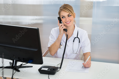 Female Doctor Talking On Telephone