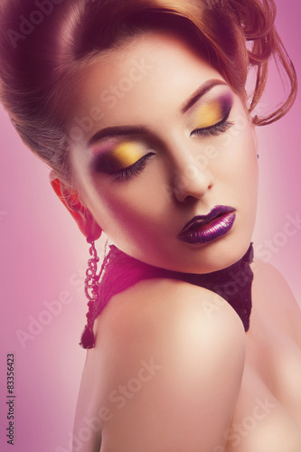 Portrait of gorgeous woman with closed eyes and make up in studi