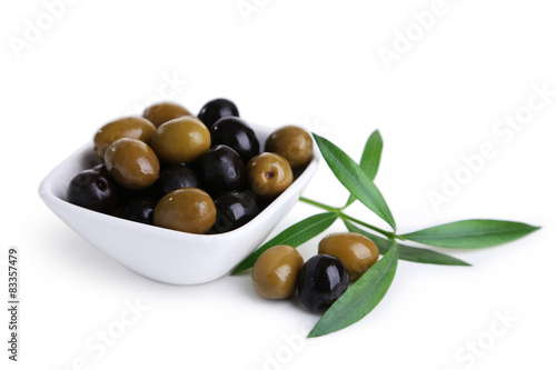 Green and black olives in bowl isolated on white