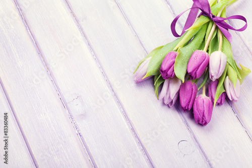 Fototapeta Naklejka Na Ścianę i Meble -  Purple tulips over wooden table