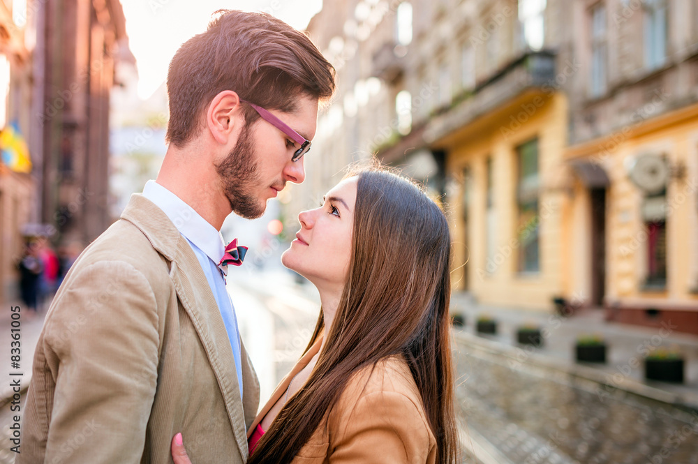 Young fashion elegant stylish couple posing on streets of europe Young fashion elegant stylish couple posing on streets of europe