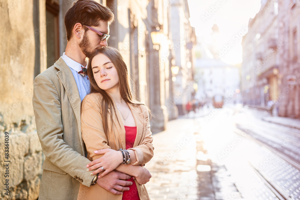 Young fashion elegant stylish couple posing on streets of europe