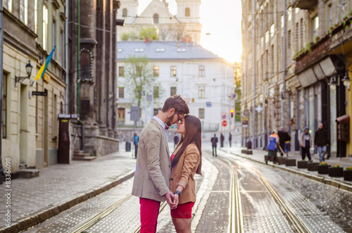 Young fashion elegant stylish couple posing on streets of europe