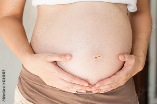 Wallpaper Mural Pregnant woman holding her hand on belly Torontodigital.ca