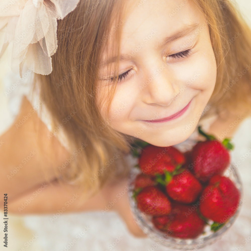 Portrait of a pretty little girl who loves strawberries. Portrait of a pretty little girl who loves strawberries.