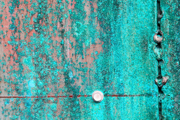 scratched and rusty green metal surface